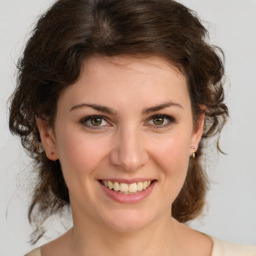 Joyful white young-adult female with medium  brown hair and green eyes