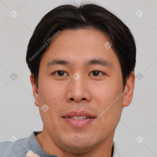 Joyful asian young-adult male with short  brown hair and brown eyes