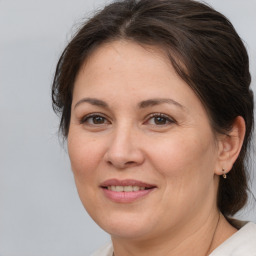 Joyful white adult female with medium  brown hair and brown eyes