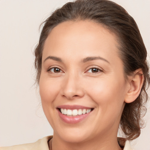 Joyful white young-adult female with medium  brown hair and brown eyes