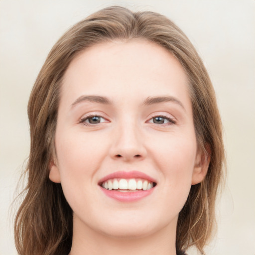 Joyful white young-adult female with medium  brown hair and blue eyes