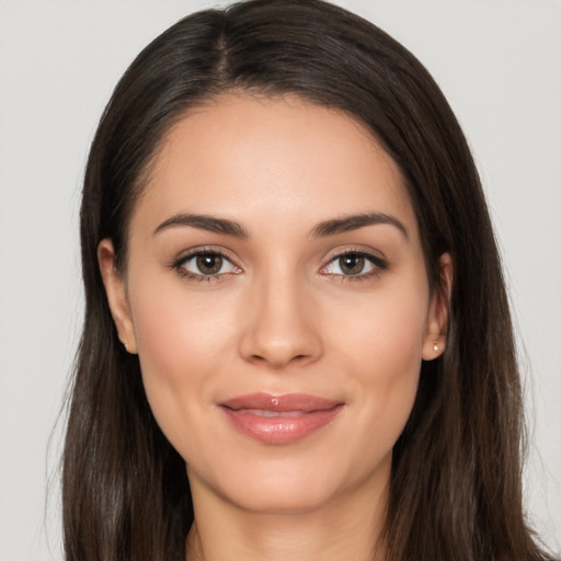 Joyful white young-adult female with long  brown hair and brown eyes