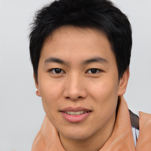 Joyful asian young-adult male with short  brown hair and brown eyes