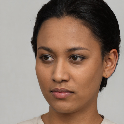 Neutral black young-adult female with short  black hair and brown eyes