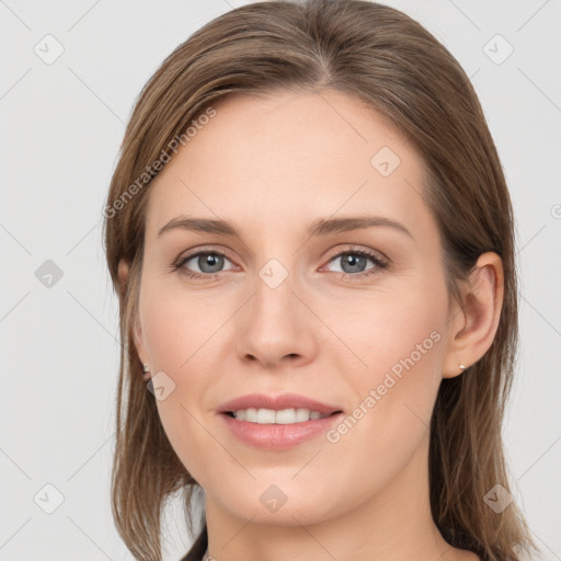 Joyful white young-adult female with long  brown hair and grey eyes