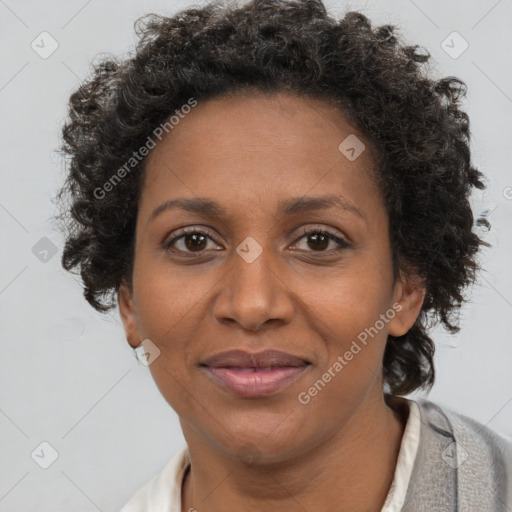 Joyful black adult female with short  brown hair and brown eyes