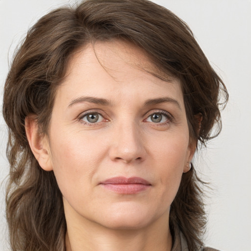 Joyful white adult female with medium  brown hair and grey eyes