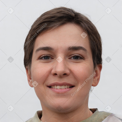 Joyful white young-adult female with short  brown hair and grey eyes