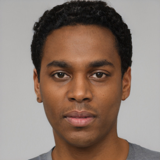 Neutral black young-adult male with short  black hair and brown eyes