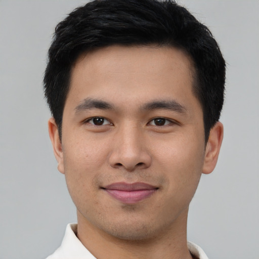 Joyful asian young-adult male with short  brown hair and brown eyes