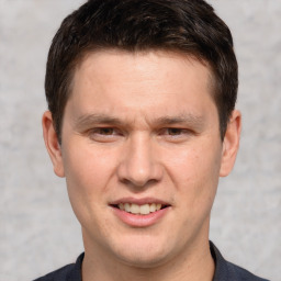 Joyful white adult male with short  brown hair and brown eyes