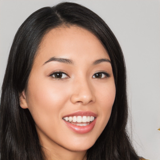 Joyful white young-adult female with long  black hair and brown eyes