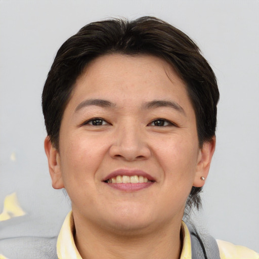 Joyful asian young-adult female with short  brown hair and brown eyes