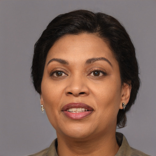 Joyful latino adult female with medium  brown hair and brown eyes