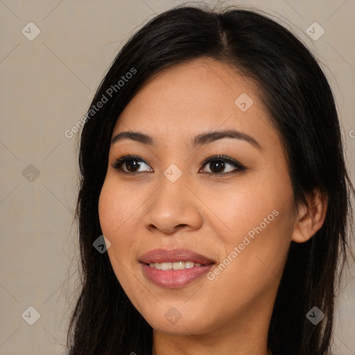 Joyful asian young-adult female with long  brown hair and brown eyes