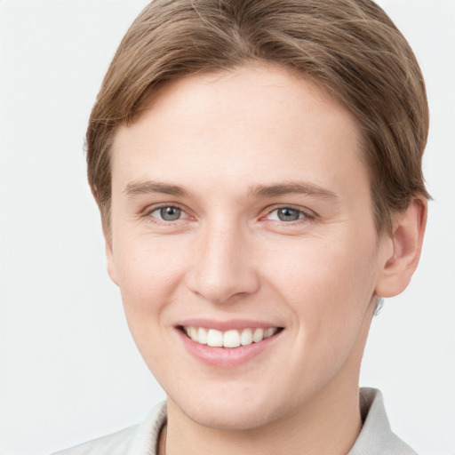 Joyful white young-adult female with short  brown hair and grey eyes