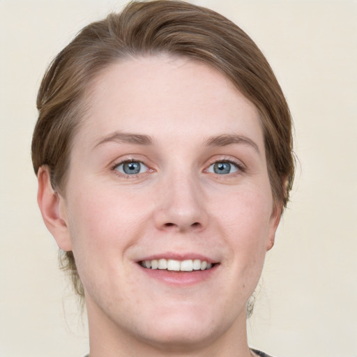 Joyful white young-adult female with medium  brown hair and green eyes