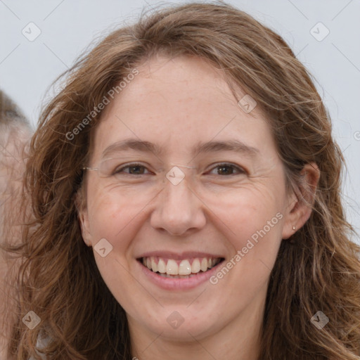 Joyful white adult female with long  brown hair and grey eyes