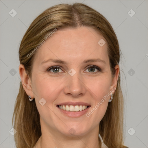 Joyful white young-adult female with medium  brown hair and grey eyes