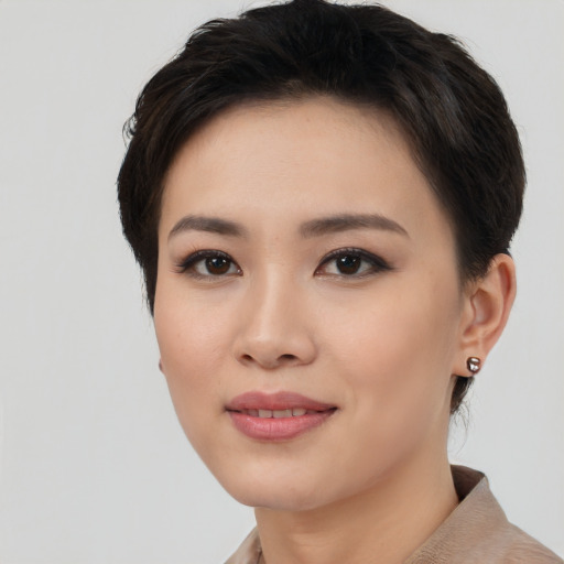 Joyful asian young-adult female with short  black hair and brown eyes