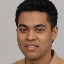 Joyful latino young-adult male with short  black hair and brown eyes