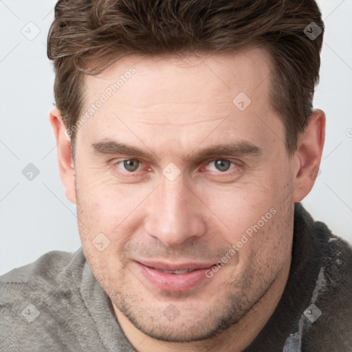 Joyful white adult male with short  brown hair and grey eyes