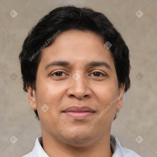 Joyful latino adult male with short  brown hair and brown eyes