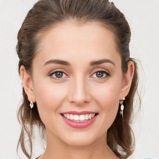 Joyful white young-adult female with medium  brown hair and grey eyes