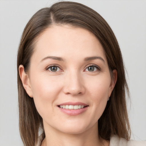 Joyful white young-adult female with medium  brown hair and grey eyes