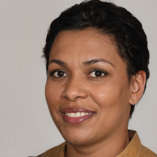 Joyful latino adult female with short  black hair and brown eyes