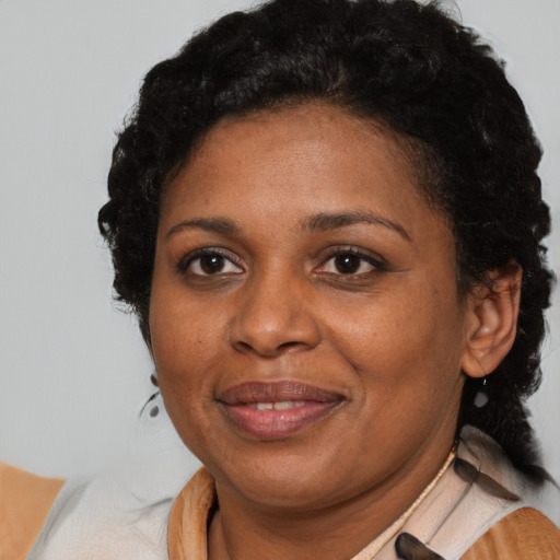 Joyful black adult female with short  black hair and brown eyes