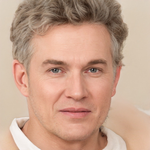 Joyful white adult male with short  brown hair and grey eyes