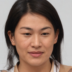 Joyful asian adult female with medium  brown hair and brown eyes