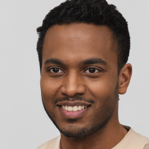 Joyful black young-adult male with short  black hair and brown eyes