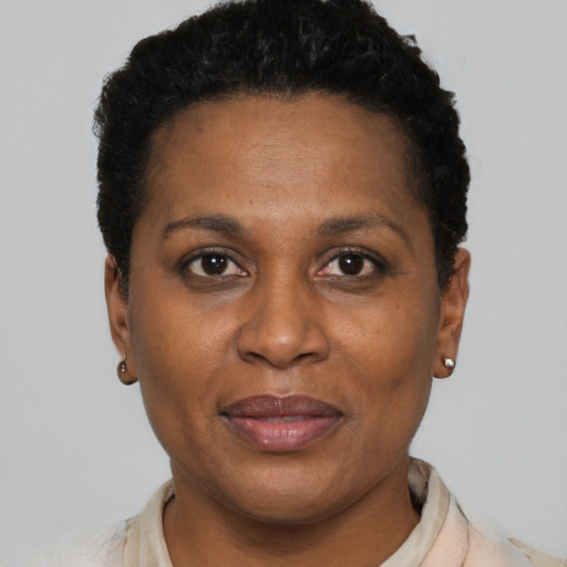 Joyful black adult female with short  black hair and brown eyes