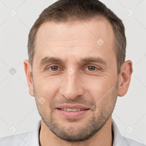 Joyful white adult male with short  brown hair and brown eyes