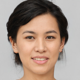 Joyful asian young-adult female with medium  brown hair and brown eyes