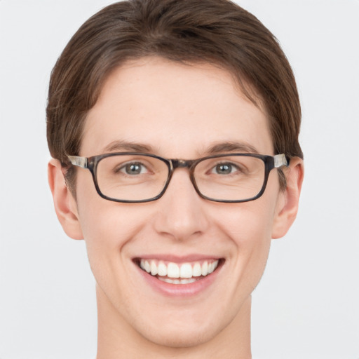 Joyful white young-adult female with short  brown hair and green eyes