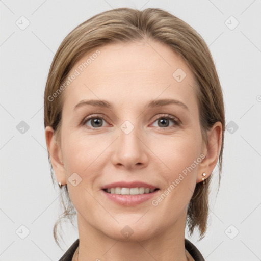 Joyful white young-adult female with medium  brown hair and grey eyes