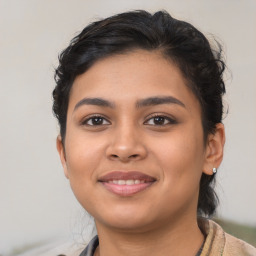 Joyful latino young-adult female with short  brown hair and brown eyes