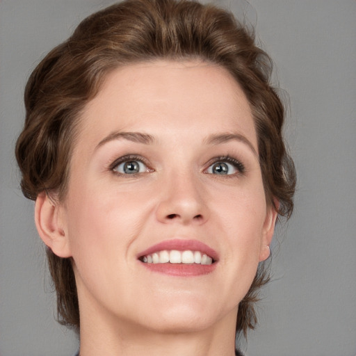 Joyful white young-adult female with medium  brown hair and blue eyes