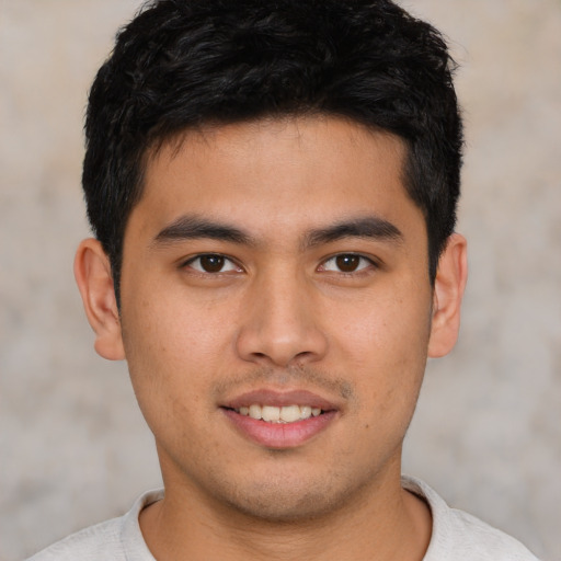 Joyful asian young-adult male with short  brown hair and brown eyes