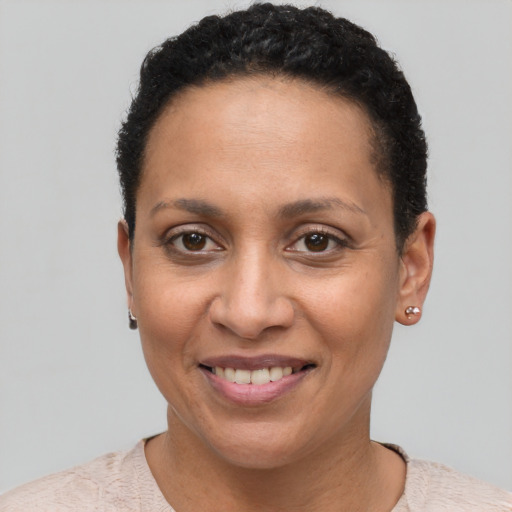 Joyful latino young-adult female with short  brown hair and brown eyes