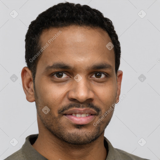 Joyful black young-adult male with short  black hair and brown eyes