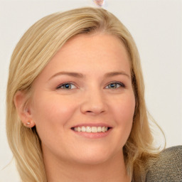 Joyful white young-adult female with long  brown hair and blue eyes