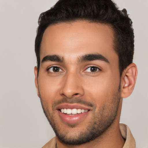 Joyful latino young-adult male with short  brown hair and brown eyes