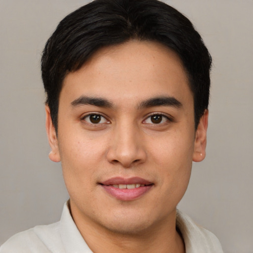 Joyful white young-adult male with short  black hair and brown eyes