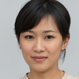 Joyful asian young-adult female with medium  brown hair and brown eyes