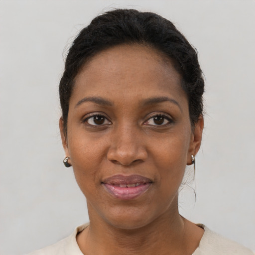 Joyful black young-adult female with short  black hair and brown eyes