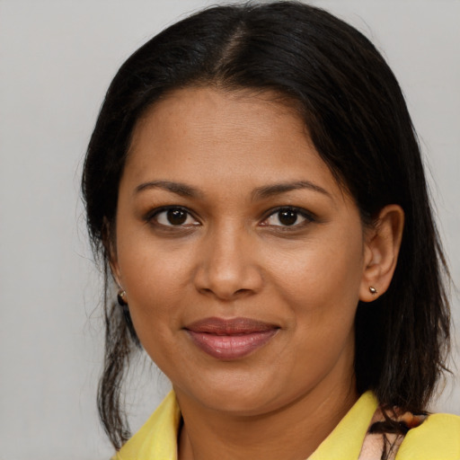 Joyful black young-adult female with medium  brown hair and brown eyes